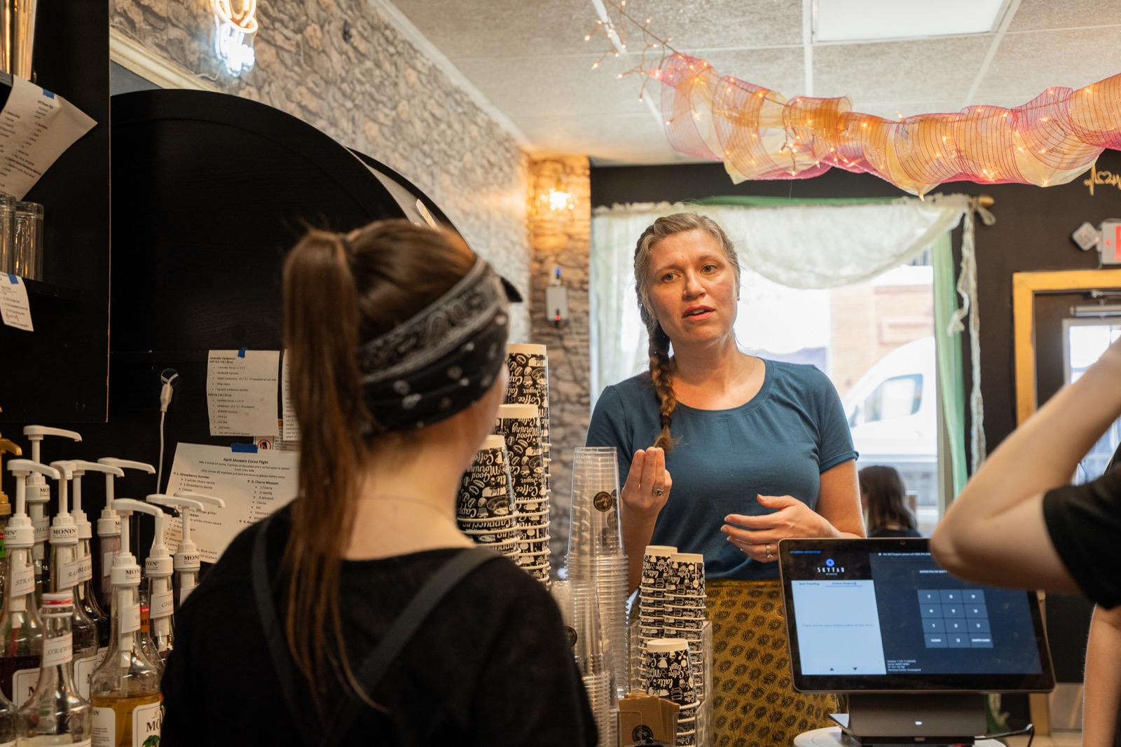 Elisa Berry coaching a cafe partner on upselling at the counter