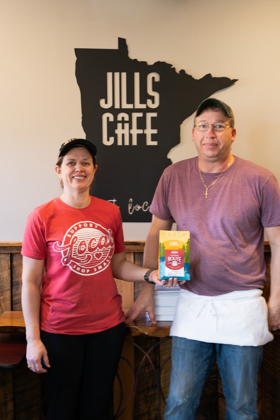 The owners of Jills Cafe holding an Ember Route 29 coffee bag